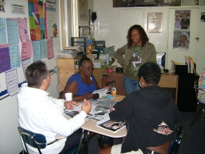 Principal (standing) Kianna Nesbit chats with parents at a Y.O.'s design workshop.